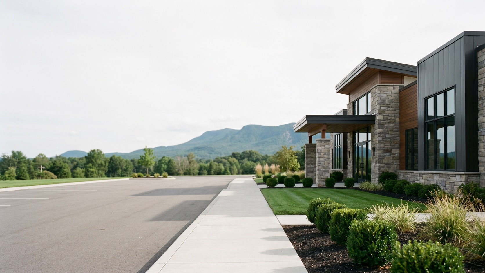 Pristine commercial landscape maintained by ManageMowed with Cheyenne Mountain in the background